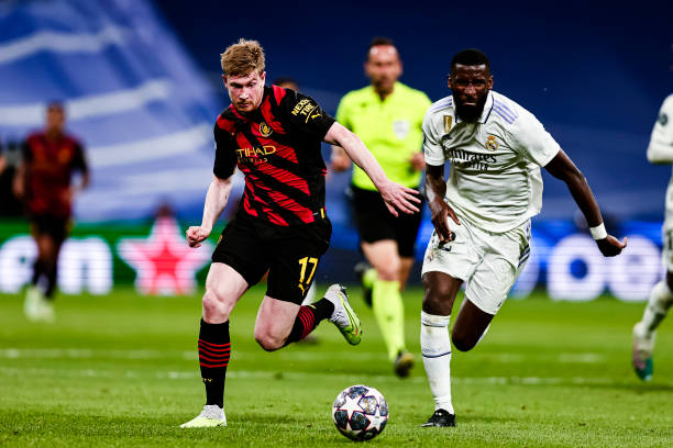 Antonio Rudiger and Kevin De Bruyne vying for the ball during the UEFA Champions League semi-final match between Real Madrid and Manchester City.